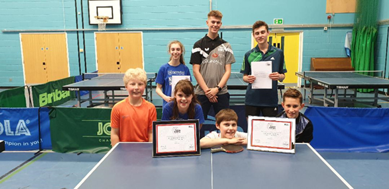 Young Ambassadors Ella and Ed receiving their 10 hour volunteering certificate from coach Nathan Downes, alongside some of the young players they work with.